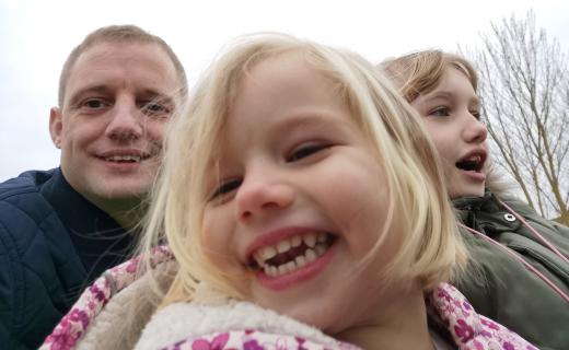 A selfie of me and my daughters on a theme park ride. 