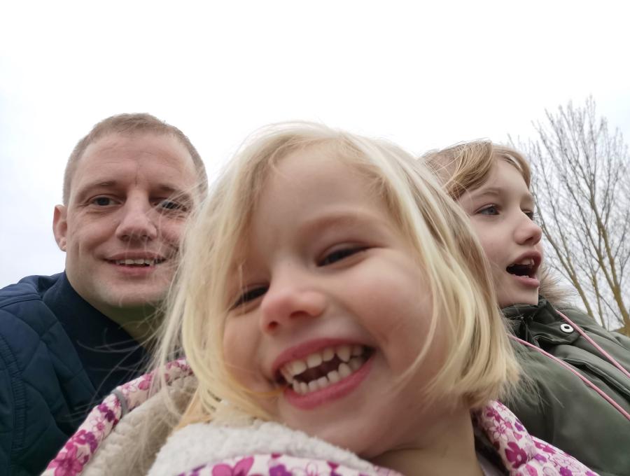 A selfie of me and my daughters on a theme park ride. 